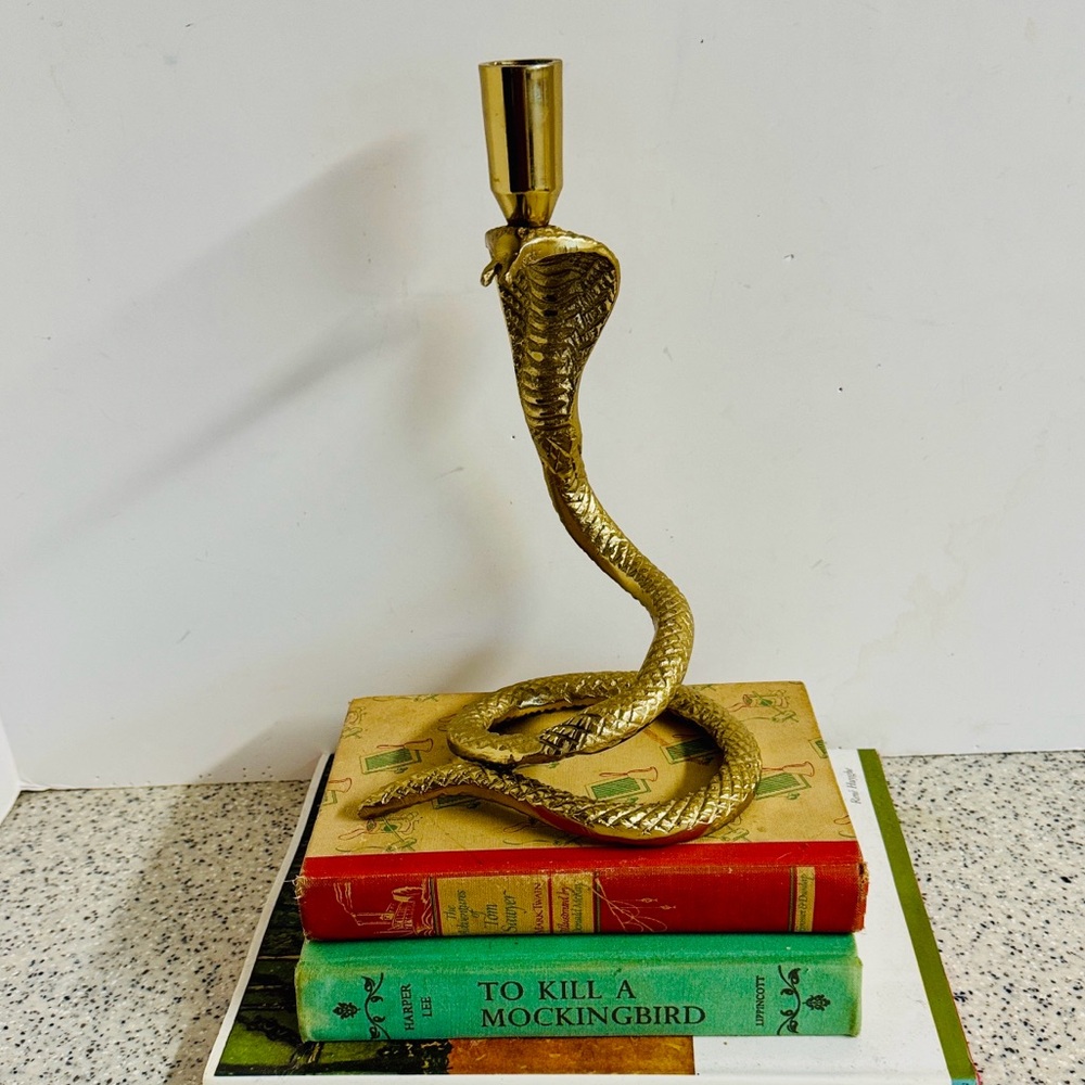 Cobra gold tone metal candlestick for tapered candle.